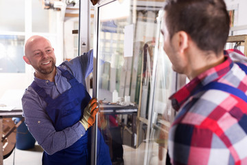 Two workers inspecting windows