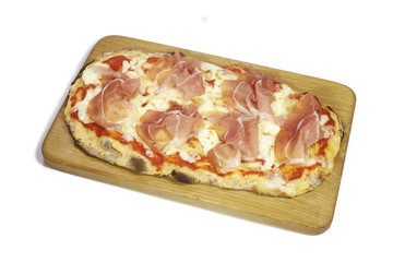 Pizza with ham on wooden cutting board