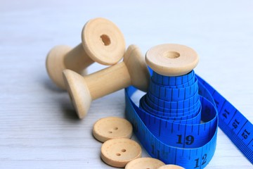 Measure tape and bobbin and wood buttons.