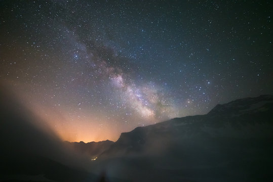 Idyllic Milky Way with clouds and fog in the Alps