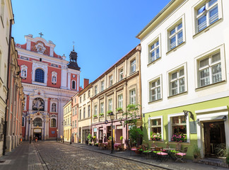 Old town in Poznan, street Świętosławska & facade of the baroque  parish church.