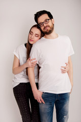 Fototapeta premium Young couple embracing and looking at the camera
