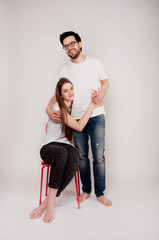 Young couple embracing and looking at the camera