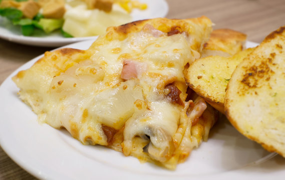 Closeup view of an appetising ham and pineapple Italian pizza wi