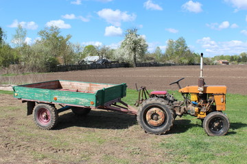 Fototapeta premium old tractor with trailer in the village
