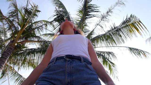 Woman Enjoying Beach Holidays and the Sun against Palm Tree.