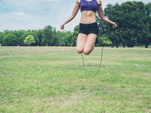 Young woman skipping in the park