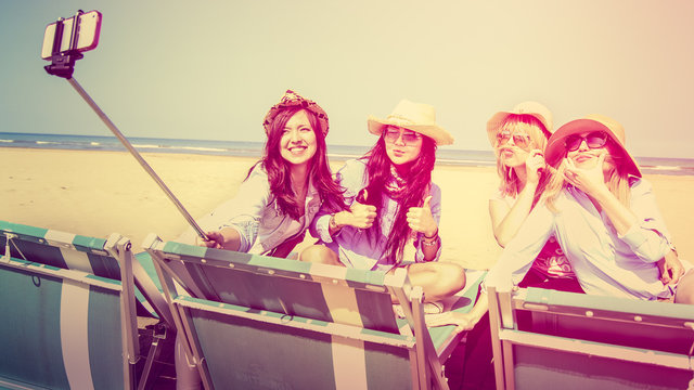 best friends 4 girls taking a self portrait on beach, photo with vintage look filter and custom white balance.