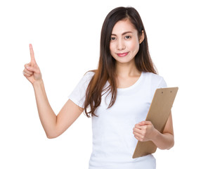 Young woman holding a clipboard and finger pointing up