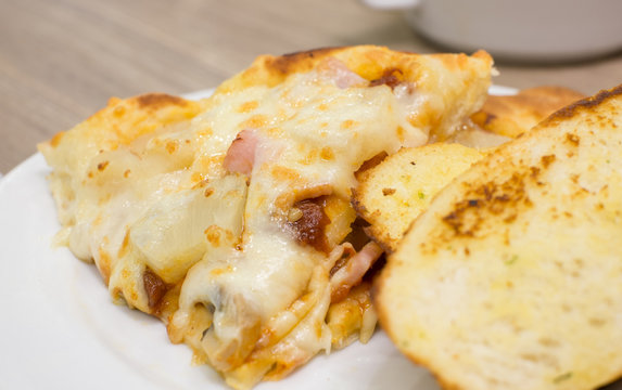 Closeup view of an appetising ham and pineapple Italian pizza wi