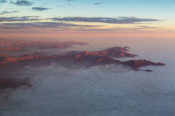 The Andes mountains rising out of a stratus cloudlayer
