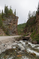 Mountain road among the rocks of the river