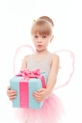 Pleasant little girl holding present 