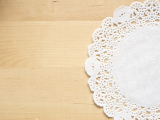 Lace paper on wooden table