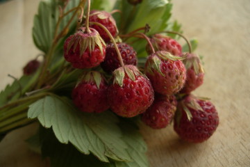 Wild strawberry on a wooden board