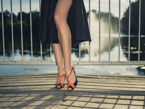 Feet and legs of elegant woman by lake