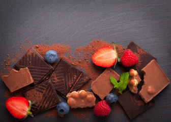 berries and chocolate on the black background