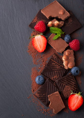 berries and chocolate on the black background