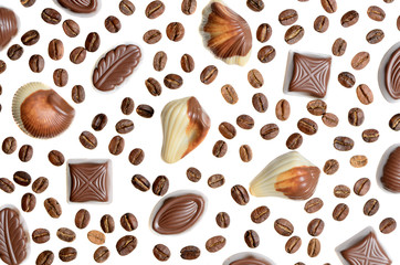 Assorted chocolate candy on the background of coffee beans isola