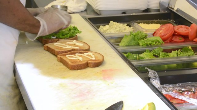 Chef preparing a BLT sandwich
