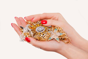 Hands holding expensive gold jewelry