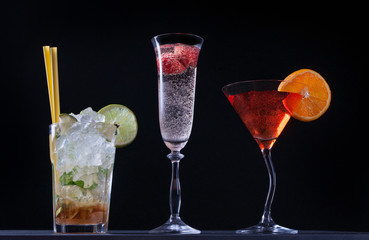Set of alcoholic cocktails on black background.