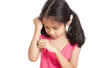 Fototapeta premium Little asian girl hurt with bandage on her arm