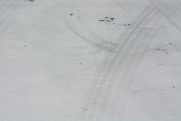 crossing tires tracks on concrete road