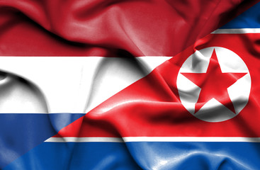 Waving flag of North Korea and Netherlands