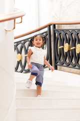 Little girl walking downstair