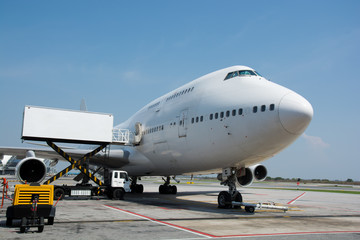Naklejka na ściany i meble Airplane near the terminal in an airport
