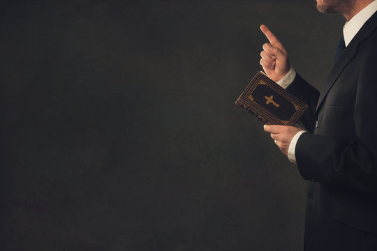 Man with a Bible and a wagging finger