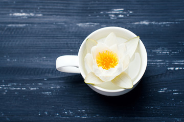 Cup of flowers on a wooden background
