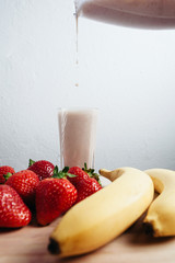 strawberry banana smoothie fresh blended on wood table