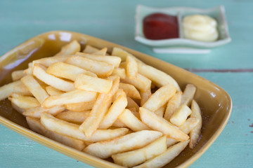 Traditional French fries with ketchup on dish