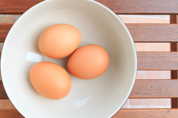 Three eggs on white disk