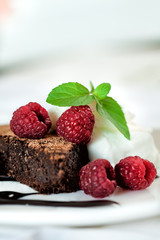 Chocolate brownie with raspberry and mint