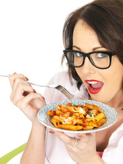 Young Woman Wearing Glasses Holding and Eating Penne Pasta