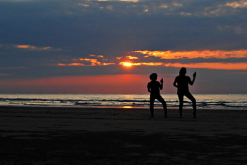 Healthy lifestyle : Silhouette of two girls practicing the karat