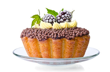 beautiful sweet cake with cream and blackberries over the glass