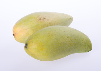 mangos or green yellow mangos on background.