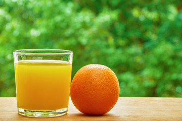 Orange and glass on the table
