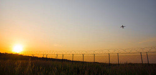 starting airplane in front of a the evening sun