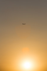 airplane in front of a hot evening sun