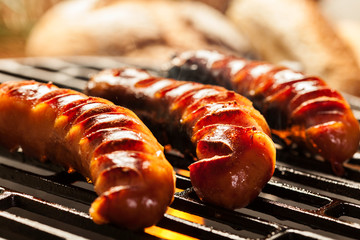 Grilling sausages on barbecue grill