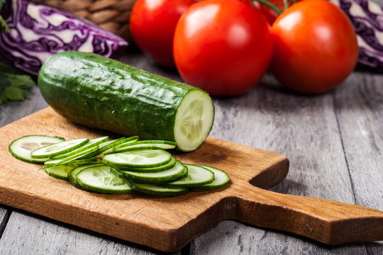 Chopped vegetables: cucumber on cutting board