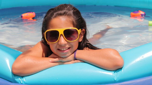 Portrait of girl enjoying in swiming pool