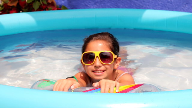 Portrait of smiling girl in swiming pool