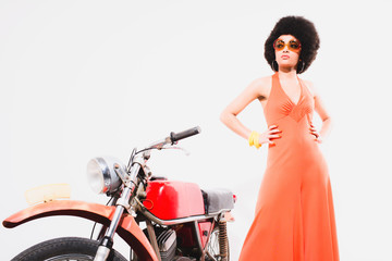 Fototapeta na wymiar Elegant Young Woman Standing Beside Motorcycle