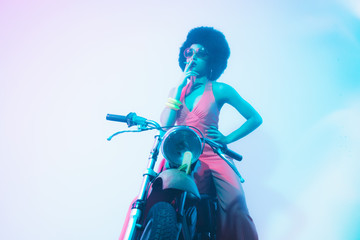 Fototapeta premium Smoking Elegant Woman Posing on her Motorcycle
